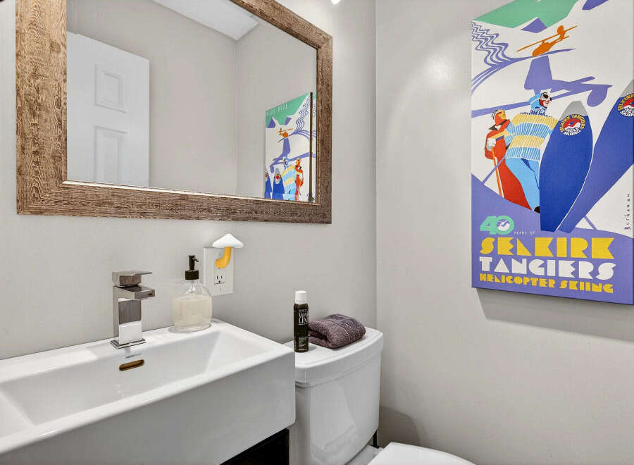 This stylish bathroom features a modern sink, a sleek faucet, and a decorative mirror.