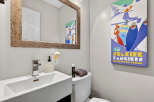 This stylish bathroom features a modern sink, a sleek faucet, and a decorative mirror.