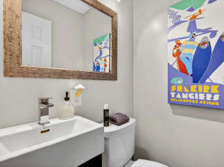 This stylish bathroom features a modern sink, a sleek faucet, and a decorative mirror.