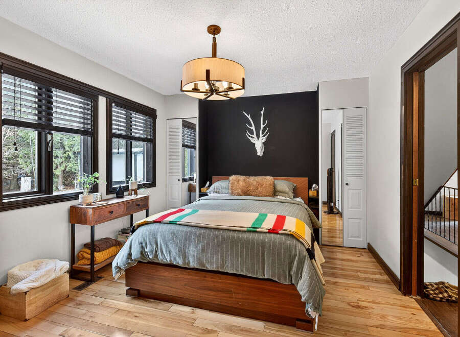 This stunning bedroom boasts a modern design with a touch of rustic charm.