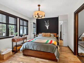 This stunning bedroom boasts a modern design with a touch of rustic charm.