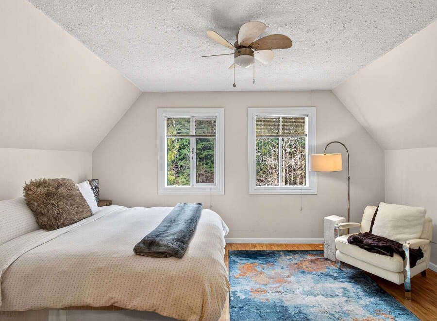 This cozy bedroom features a comfortable bed with a plush throw and pillow, perfect for relaxing.