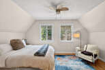 This cozy bedroom features a comfortable bed with a plush throw and pillow, perfect for relaxing.
