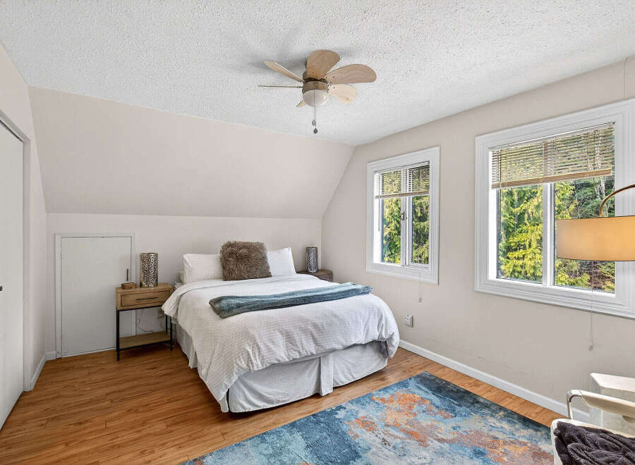This charming bedroom offers a cozy retreat with its inviting ambiance and natural light.