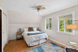 This charming bedroom offers a cozy retreat with its inviting ambiance and natural light.