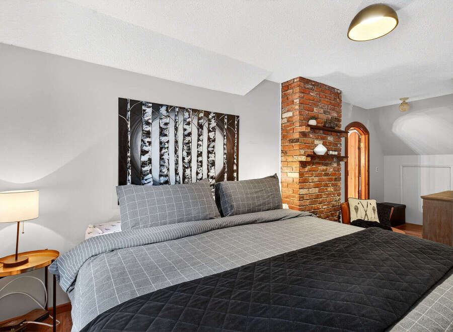 Discover the charm of this inviting bedroom, featuring a cozy bed adorned with stylish bedding.