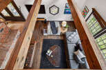 Step into this stunning home featuring a cozy living area with a brick fireplace and exposed wooden beams.