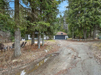 Discover the tranquility of this charming property nestled amidst lush greenery.