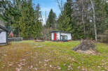Discover the charm of this property, featuring a cozy cabin with a vibrant red door.