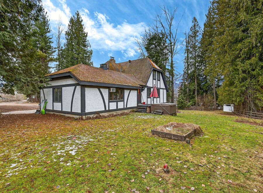 This charming Tudor-style home offers a unique blend of classic architecture and modern comfort.