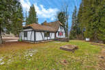 This charming Tudor-style home offers a unique blend of classic architecture and modern comfort.