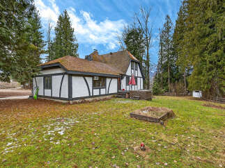 This charming Tudor-style home offers a unique blend of classic architecture and modern comfort.