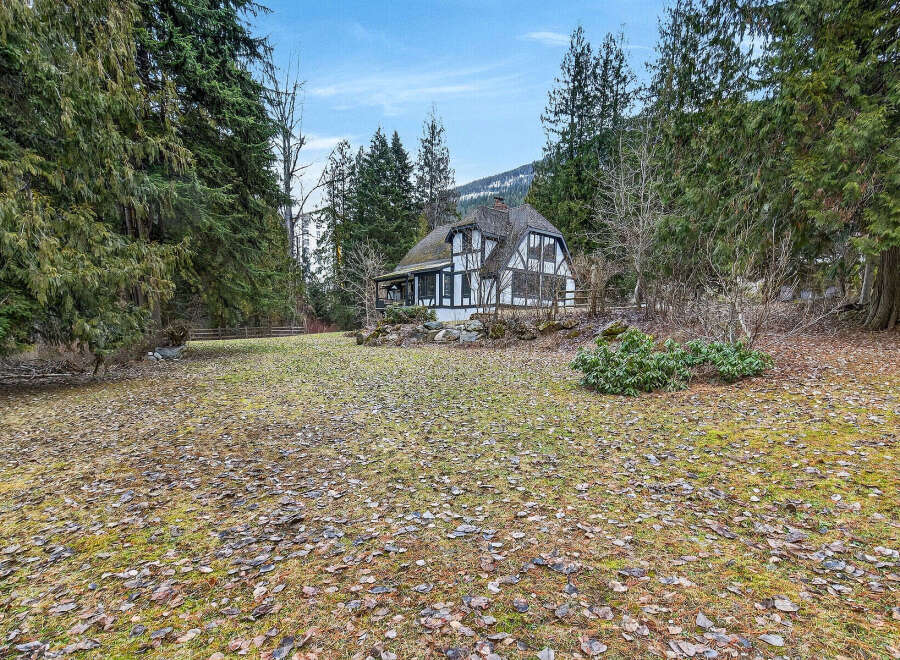Nestled amidst lush greenery, this charming property boasts a unique architectural design.