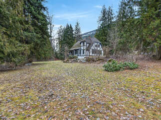 Nestled amidst lush greenery, this charming property boasts a unique architectural design.