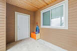 This charming property boasts a welcoming entrance with a bright white door and a convenient storage box.