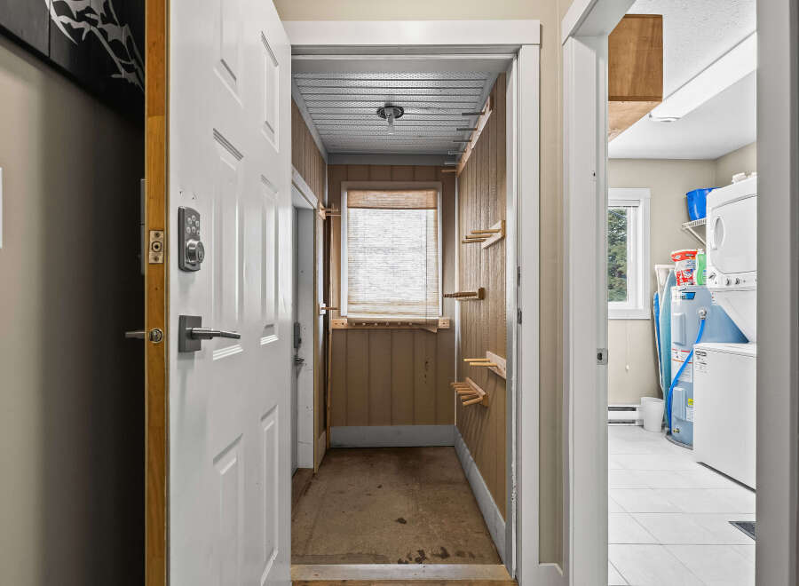 Step into this inviting home and discover a functional entryway leading to a well-organized laundry area.