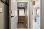 Step into this inviting home and discover a functional entryway leading to a well-organized laundry area.