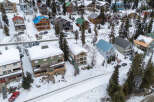 Discover a charming mountain retreat nestled in a snowy landscape, perfect for a cozy getaway.