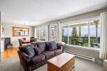This stunning property boasts a cozy living room with a comfortable sofa and ample natural light.