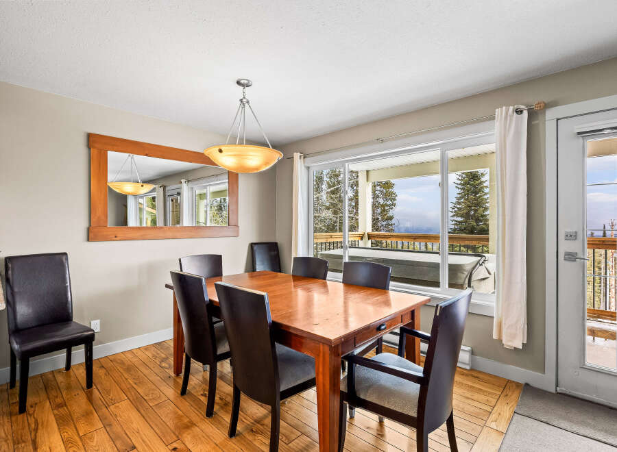 This stunning dining area features a beautiful wooden table and chairs, perfect for hosting family gatherings.