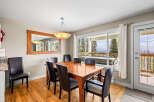 This stunning dining area features a beautiful wooden table and chairs, perfect for hosting family gatherings.