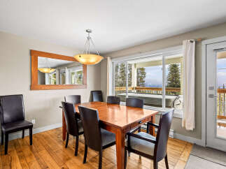 This stunning dining area features a beautiful wooden table and chairs, perfect for hosting family gatherings.