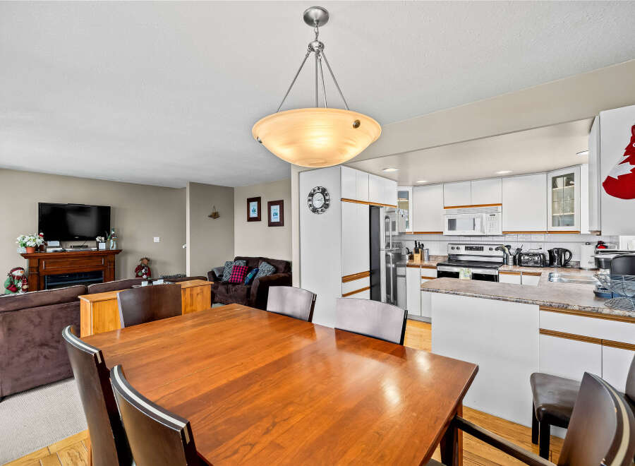 This inviting dining area seamlessly connects to the kitchen, creating a perfect space for entertaining.