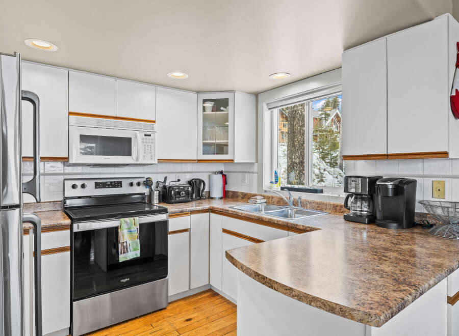 This charming kitchen boasts a bright and airy atmosphere, perfect for culinary adventures.
