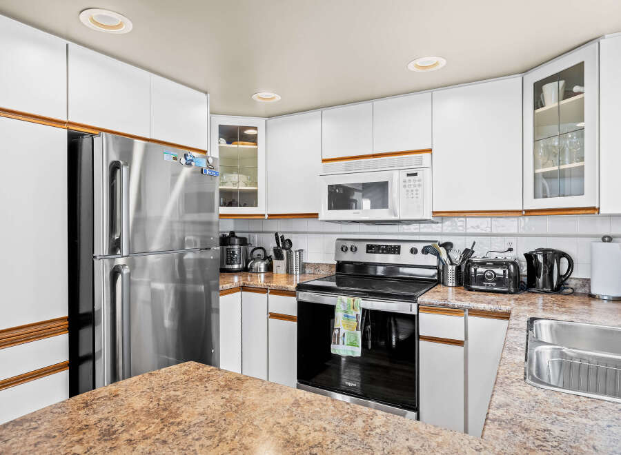 This stunning kitchen boasts modern appliances and ample counter space, perfect for culinary enthusiasts.