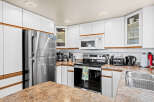 This stunning kitchen boasts modern appliances and ample counter space, perfect for culinary enthusiasts.