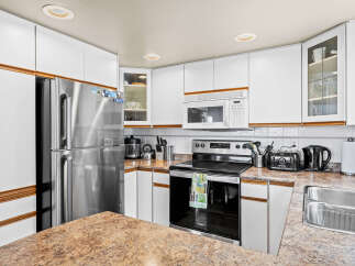 This stunning kitchen boasts modern appliances and ample counter space, perfect for culinary enthusiasts.