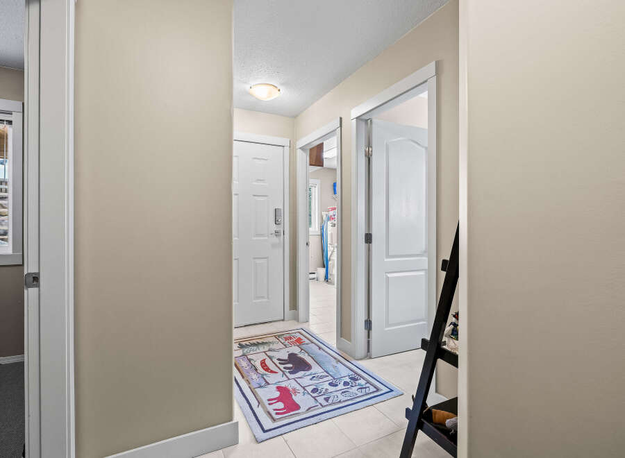 Step into this inviting entryway, showcasing a stylish rug and neutral walls.