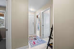 Step into this inviting entryway, showcasing a stylish rug and neutral walls.