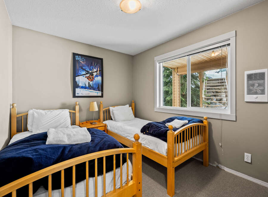 This cozy bedroom features two twin beds, perfect for guests or children.