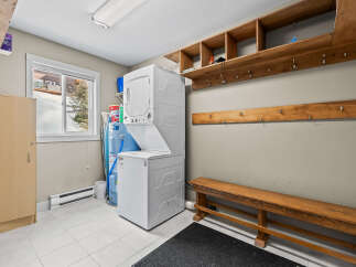 This laundry room offers a functional and organized space for all your washing needs.