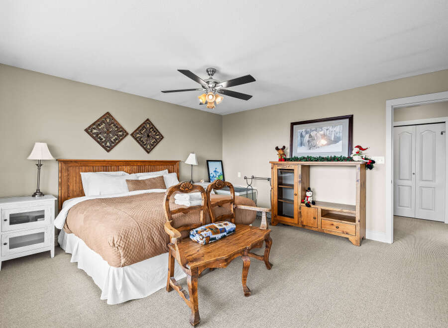 This cozy bedroom features a comfortable bed with a stylish headboard and a warm, inviting color palette.