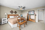 This cozy bedroom features a comfortable bed with a stylish headboard and a warm, inviting color palette.