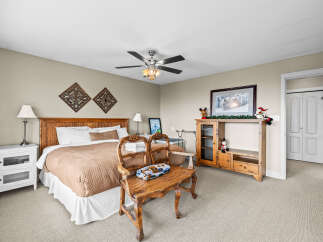 This cozy bedroom features a comfortable bed with a stylish headboard and a warm, inviting color palette.
