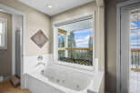 Enjoy the tranquility of this luxurious bathroom featuring a spa-like soaking tub.