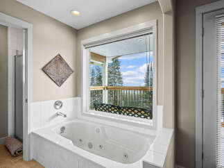 Enjoy the tranquility of this luxurious bathroom featuring a spa-like soaking tub.