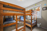 This cozy bedroom features two sets of bunk beds, perfect for accommodating multiple guests or family members.