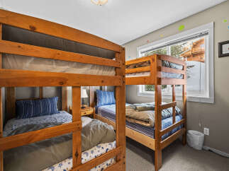This cozy bedroom features two sets of bunk beds, perfect for accommodating multiple guests or family members.