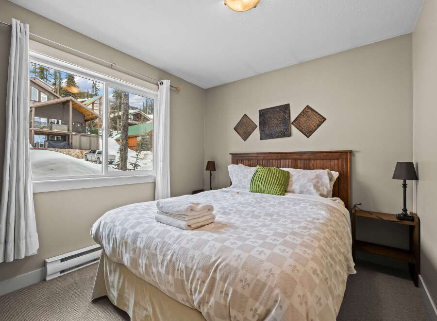 This cozy bedroom offers a serene retreat with its inviting ambiance and stylish decor.