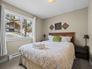 This cozy bedroom offers a serene retreat with its inviting ambiance and stylish decor.