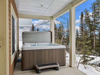 Relax and unwind in this stunning property featuring a luxurious hot tub, perfect for enjoying the beautiful outdoor scenery.