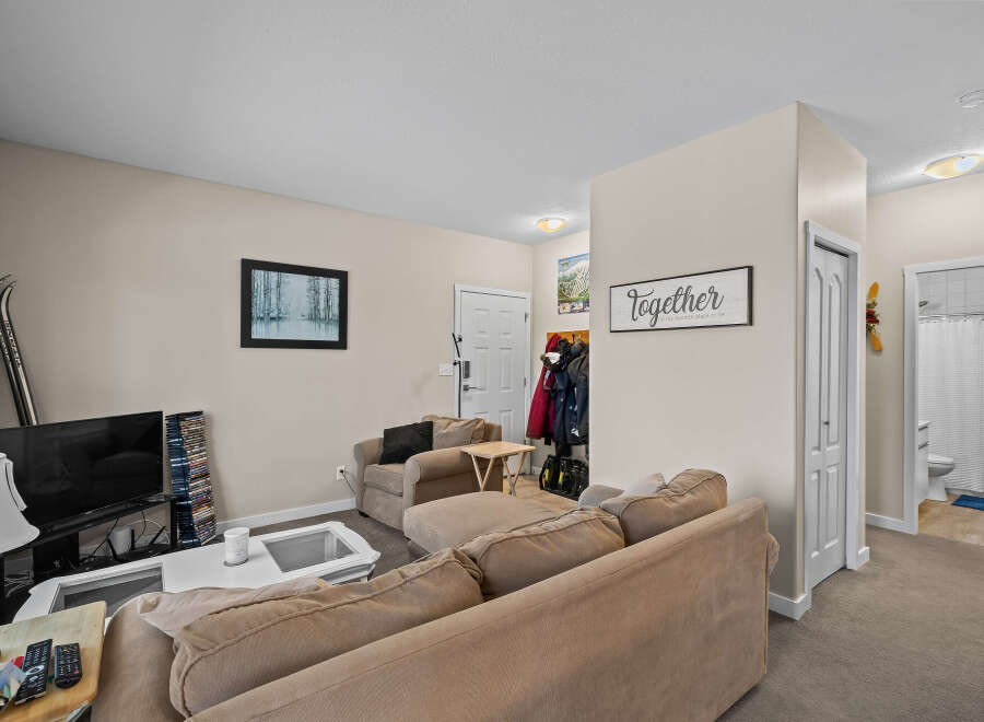 This cozy living space features a comfortable sectional sofa, perfect for relaxing.