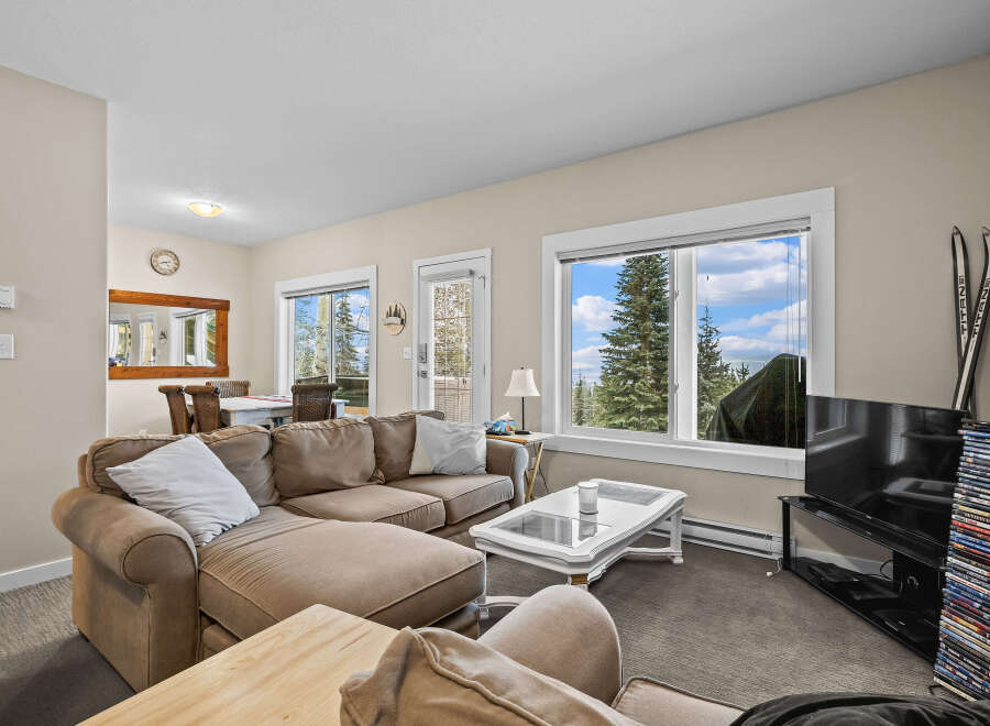 This cozy living room features a comfortable sectional sofa, perfect for relaxing after a day of outdoor adventures.