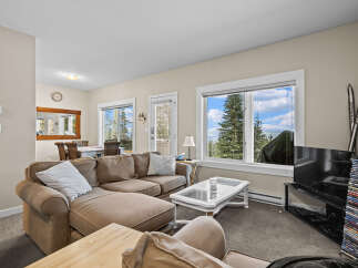 This cozy living room features a comfortable sectional sofa, perfect for relaxing after a day of outdoor adventures.