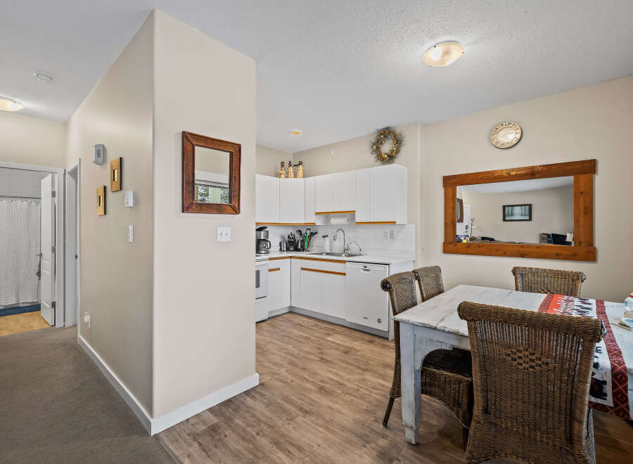 Step into this inviting space, featuring a well-lit kitchen with modern appliances and ample counter space.
