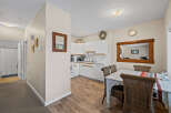 Step into this inviting space, featuring a well-lit kitchen with modern appliances and ample counter space.